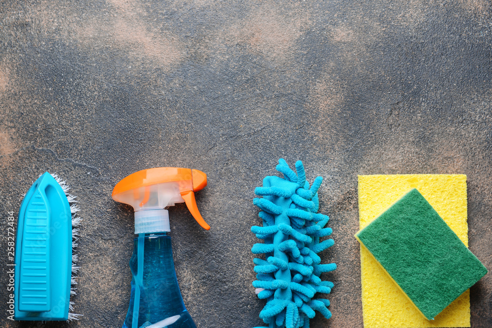 Set of cleaning supplies on grunge background