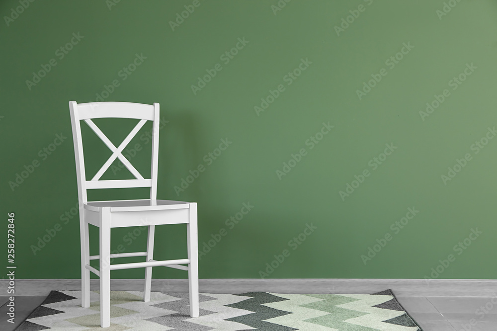 Chair near color wall in room