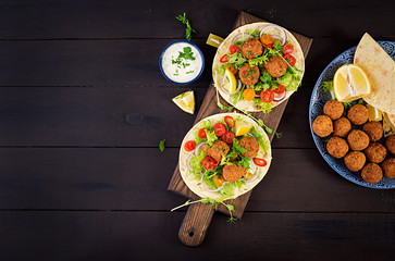 Tortilla wrap with falafel and fresh salad. Vegan tacos. Vegetarian healthy food. Top view