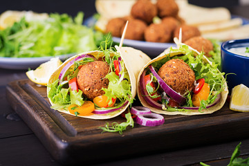 Tortilla wrap with falafel and fresh salad. Vegan tacos. Vegetarian healthy food.