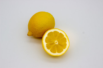 Wall Mural - One lemon and half a lemon isolated image on a white background