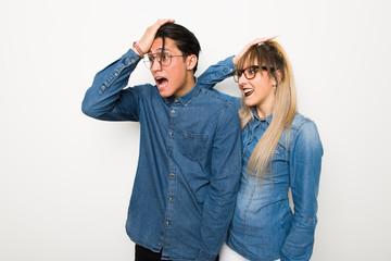 Wall Mural - Young couple with glasses has just realized something and has intending the solution