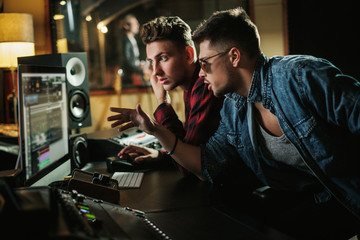 Wall Mural - Sound engineer working in a music studio