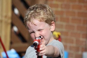 Little boy with toy gun