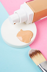 Liquid foundation makeup with brush and sponge.