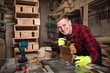 © Novak - Male carpenter in his workshop using drill