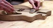 © meyerandmeyer - Making a guitar, driling hole in wood body of guitar