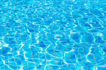 Wall Mural - blue water ripple background and texture. water surface og swimming pool in summer time.