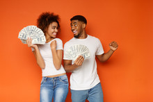 Cheerful African-american Man And Woman Enjoying Lots Of Money