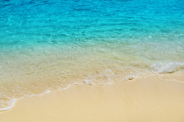 Wave of tropical sea beach on white sand