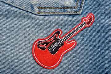red guitar patch on jeans