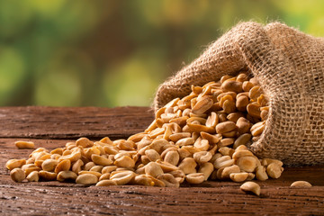 peanut in sack bag on wooden background