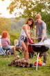 Girl and boy preparing barbecue