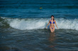 © Михаил Решетников - beautiful young woman in a seductive bikini comes out of the sea with high waves. Big waves in the ocean