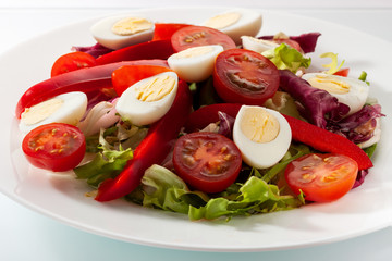 Wall Mural - Salad with fresh vegetables on a white table