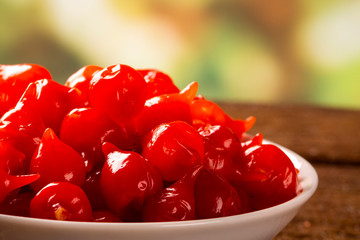 Biquinho Pepper into a bowl. Capsicum Chinense over a wooden table