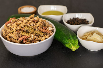 Wall Mural - Ingredients. recipe step by step fusilli pasta with zucchini on grey stone