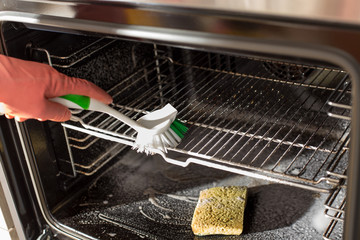 Woman cleaning oven