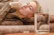 © yaroslav1986 - Sick girl lying on the couch, on the table are tablets