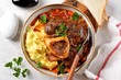 © chudo2307 - Beef shank stew with onions, carrots, celery, tomatoes, thyme and wine. Top view.
