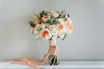 bridal bouquet. beautiful blooming bouquet of pastel pink roses with a ribbon