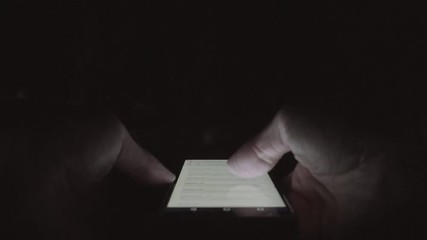 Man tourist using map application on smartphone in night city