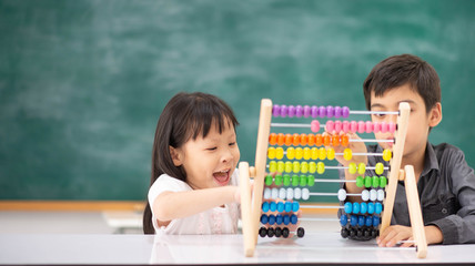 Students boy and girl leaning math in the class room Montessori