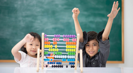 Students boy and girl leaning math in the class room Montessori