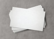 © sdecoret - White business card stack on concrete desk 3D rendering