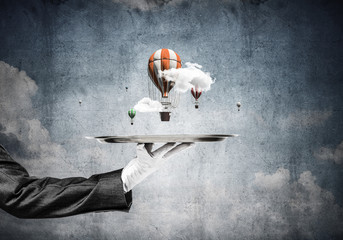 Wall Mural - Hand of waitress presenting balloons on tray.