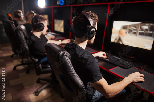 Professional Gamers participating in online cyber games tournament, sitting at pc gaming club or in internet cafe Tableau sur Toile