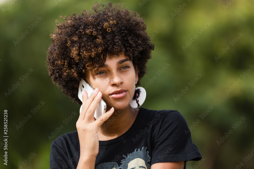 Outdoor portrait of a Young black African American young woman speaking ...