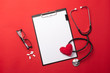 © Dz Lab - Stethoscope in doctors desk with tablet, heart and pills, top view