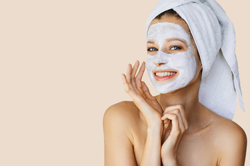 Wall Mural - beautiful young woman applying facial mask on her face. skin care and treatment, spa, natural beauty