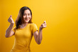 Woman in love showing heart isolated over yellow background