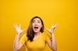 © chajamp - Angry woman screaming isolated over yellow background