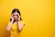 © chajamp - Woman has headache isolated over yellow background