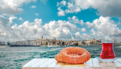 Wall Mural - Turkish tea in the background of the Golden Horn against Galata tower in Istanbul