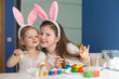 © erainbow - Girls paint easter eggs