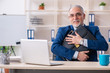 © Elnur - Aged male employee working in the office