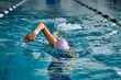 © afefelov68 - Female athlete swimming fast in crawl style.  Splashes of water scatter in different directions.