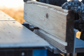 Wall Mural - saw blade. car saws wood. there is a blackboard in the background. working hand