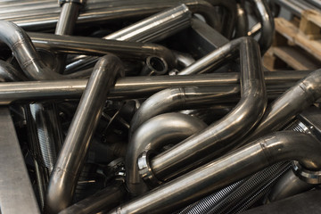 Wall Mural - Many seamless metal curved pipes in the factory.