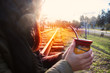 Woman drinking yerba mate drink on an abandoned rail track
