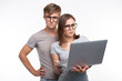 © satura_ - Nerds, study, people concept - a couple of students look at the netbook and look like scared on white background