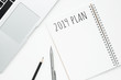 © satapatms - Notebook with 2019 plan text is on top of white office desk table. Top view, flat lay.