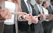 © ASDF - Hands of business people connected by ropes