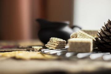 Sweet russian artek waffles on wooden background, with a pot of milk. Traditional sweets and dessert.