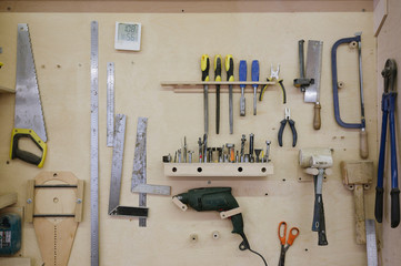 Tools hang on the wall in the carpentry workshop