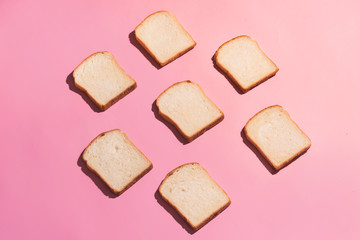 Sliced bread to toast isolated on pink background. Close up. Top view